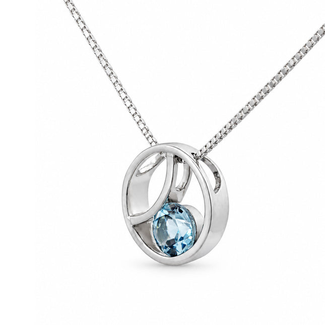 A side view of a sterling silver blue topaz pendant hanging on a sterling silver box chain