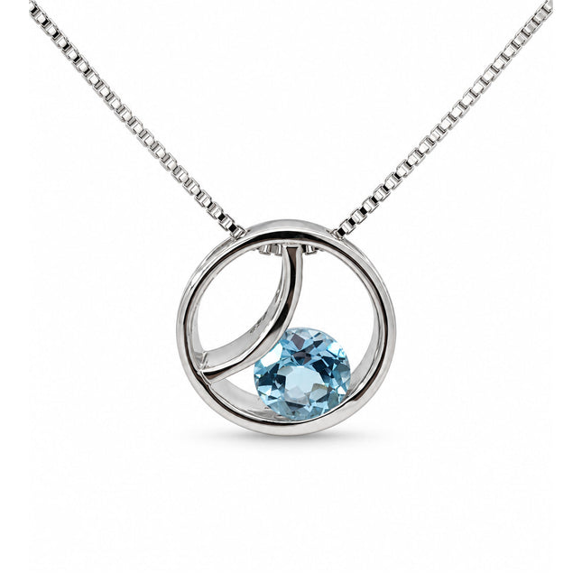 A blue topaz circle sterling silver pendant hanging on a sterling silver box chain. 