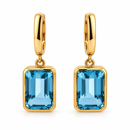 A pair of genuine blue topaz in gold plated sterling silver bezel set dangle earrings