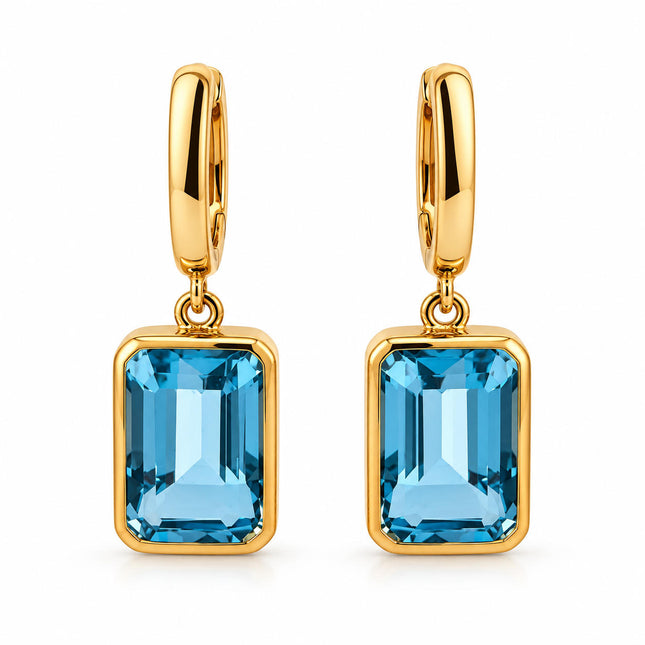 A pair of genuine blue topaz in gold plated sterling silver bezel set dangle earrings