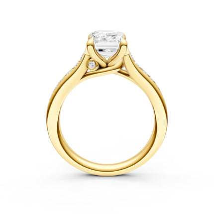 A profile view of a yellow gold diamond accent engagement ring that has a hidden diamond accent. 