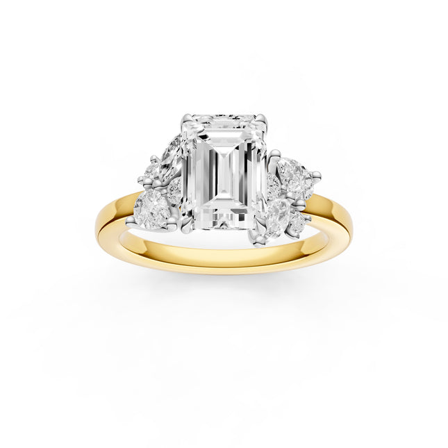 A top view of an emerald cut floral inspired diamond engagement ring in yellow gold 