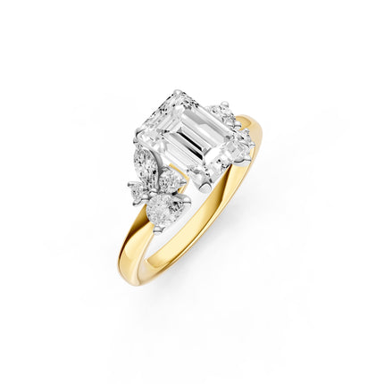 A floral-inspired, emerald cut, diamond accent engagement ring yellow gold. 