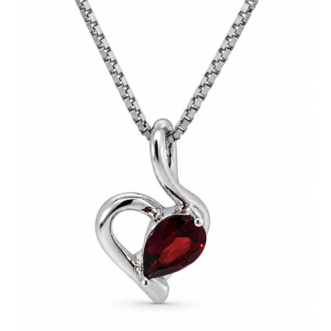 A heart shape pendant with a garnet in sterling silver hanging on a sterling silver chain. 