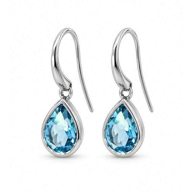 A side view of a pair of blue topaz sterling silver dangle earrings