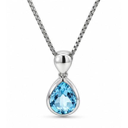 A pear shape blue topaz tear drop pendant hanging on a sterling silver necklace