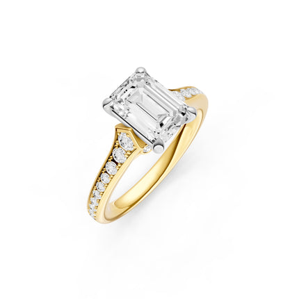 A two-tone gold, emerald, cut diamond accent engagement ring.