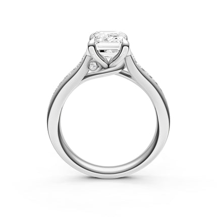 A side profile view of a white gold, diamond engagement ring with a hidden diamond accent. 