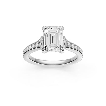 A top view of a white gold emerald cut diamond accent engagement ring. 