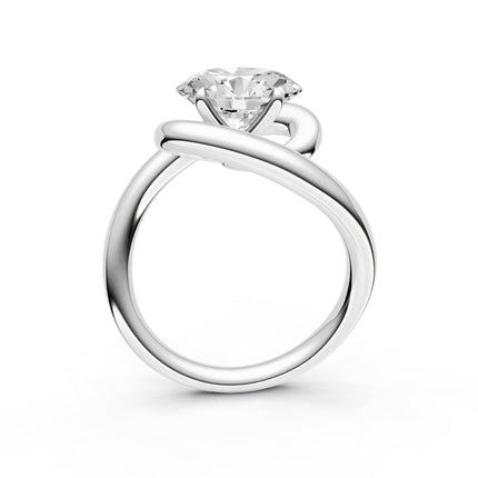A profile view of a white gold diamond engagement ring. 