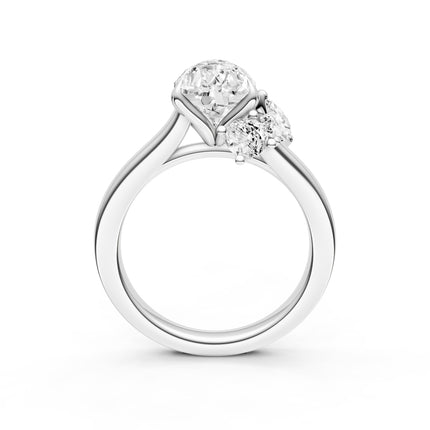 A profile view of a diamond accent engagement ring in white gold