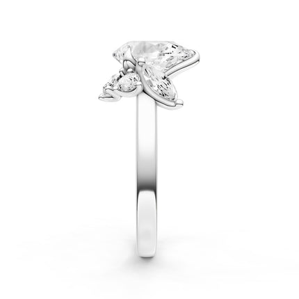 A side view of a white gold diamond accent engagement ring. 