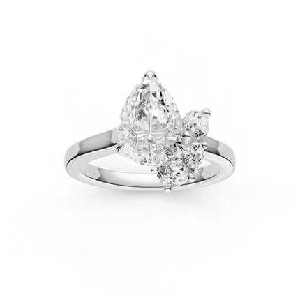 A top view of a white gold, pear shape floral diamond engagement ring. 