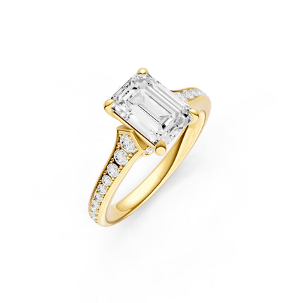 A yellow gold diamond accent emerald cut engagement ring. 