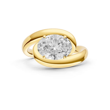 A top view of a yellow gold, oval cut, east-to-west, bypass diamond engagement ring. 